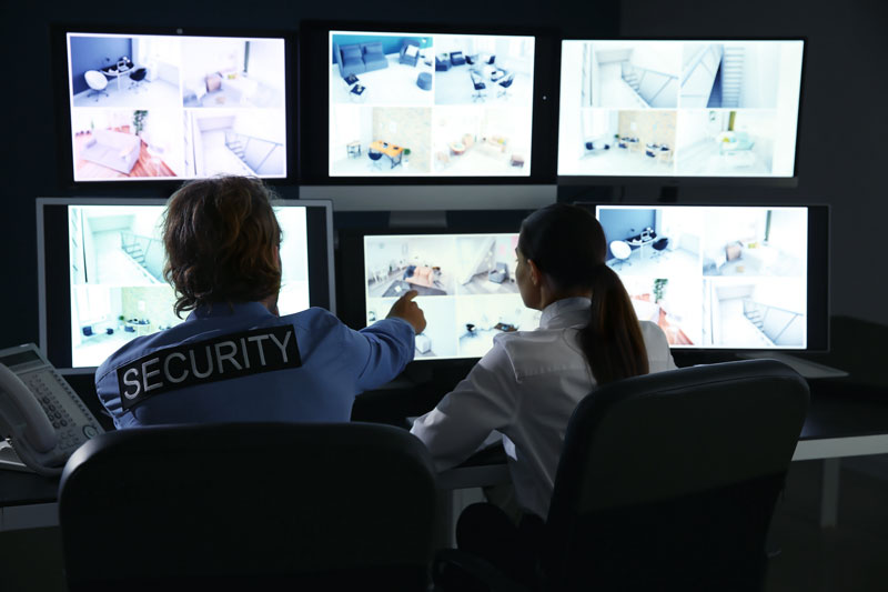 securityguardsmonitoringmoderncctvcamerasinsurveillanceroom